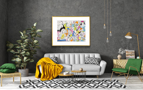gold-framed picture with a wide white matte hanging above a grey couch with various other furniture in the room 