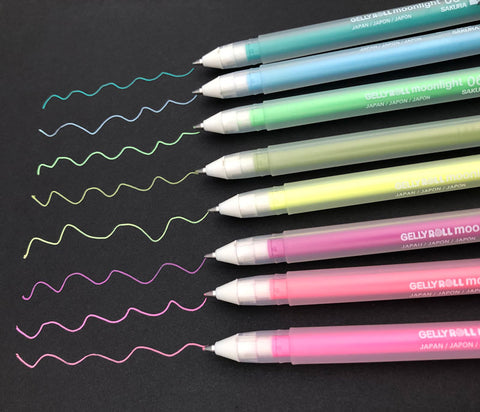 gel pens in a variety of vibrant colors writing on black matte