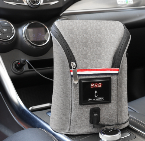 Portable car bottle warmer in modern grey fabric design, featured in a vehicle's center console. Equipped with a temperature display showing 88.8 degrees, ensuring beverages are heated to the desired warmth. Sleek, convenient for on-the-go parents, and easily accessible while driving. Shop this essential travel accessory for babies at OnlineFamStore.com.