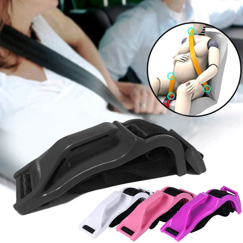 Image showcasing the ExpectingSafe™ Maternity Car Seat Belt Adapter, an accessory designed to enhance safety for pregnant drivers. The main focus is a black seat belt adapter placed in the foreground, with alternative color options like white, pink, purple, and light green displayed alongside. A smaller inset image illustrates how the adapter is used, redirecting the seat belt away from the belly of a pregnant woman to ensure comfort and protection. This product emphasizes safety and ease of use, compatible with all car models, and essential for expectant mothers.