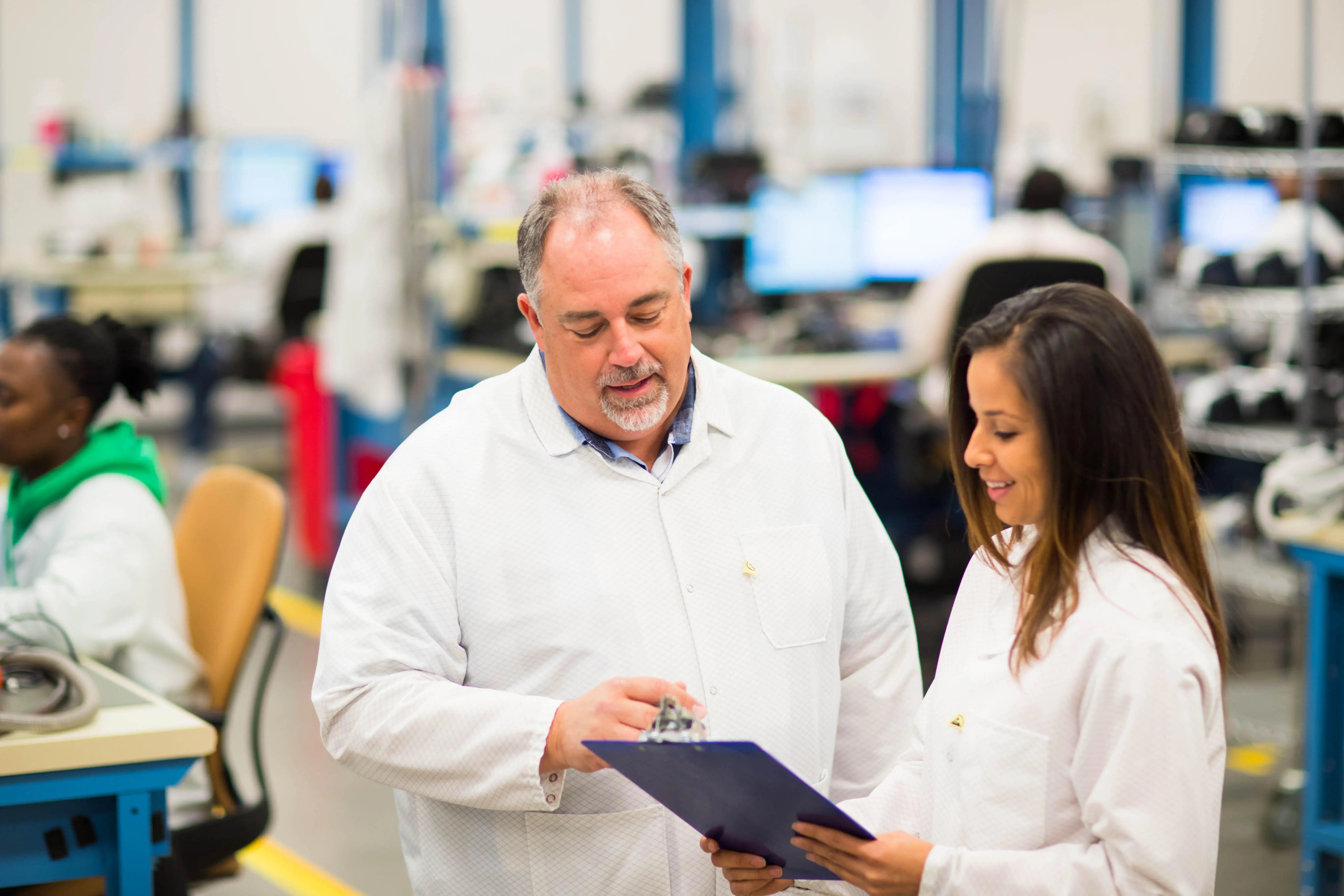 Two coworkers looking at the folder