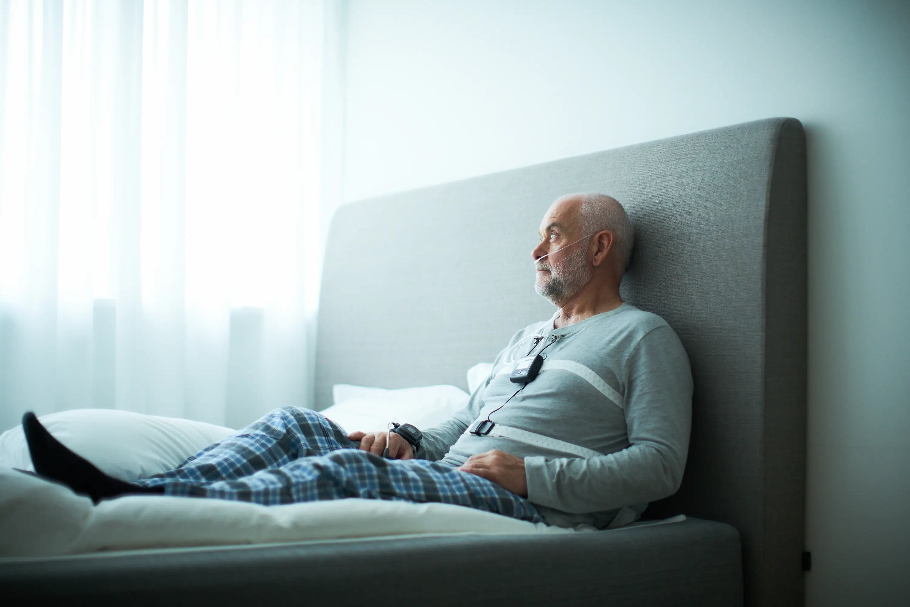 Thinking and sitting in his bed