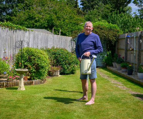 man on his greenthumb lawn