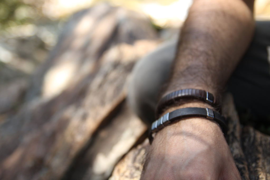 a man wearing leather bracelets 