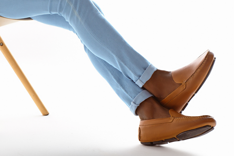 Man's legs wearing a pair of brown Sandro Moscoloni driving shoes.