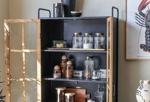image of a industrial shelving unit filled with kitchen cannisters, bowls, plates and tableware.