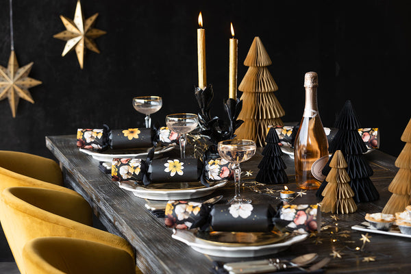 A fully set christmas table with a mustard and black theme.