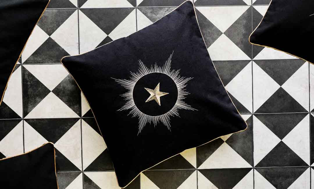 image of 15 year collection cushion embroidered with a gold star