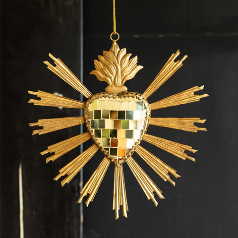 Image of the Gold Disco Ball Heart Hanging Ornament hanging in front of a black wall.