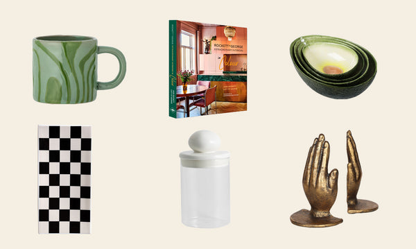 Images of gift ideas for them including a green marble mug, interior design book, avocado nesting bowls, monochrome checkered trinket dish, glass storage jar and gold holding hands bookends.
