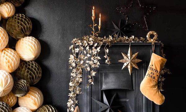 image of a cream and gold honeycomb ball Christmas tree against a gold fireplace
