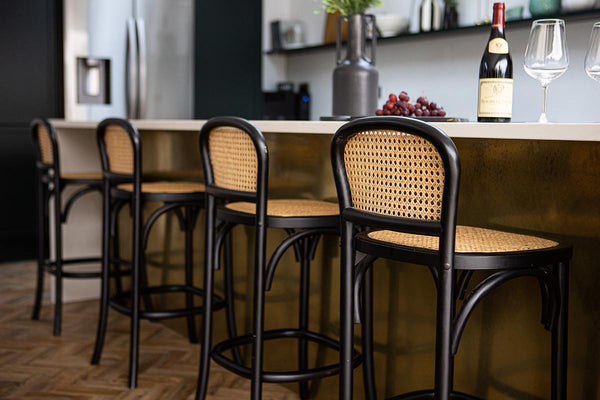 Black chez bar stools tucked underneath a kitchen island