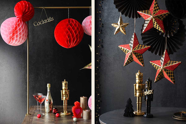 Two images - on the left an extendable clamp stand with red honeycombs hanging over the table. On the right, red and gold stars with black pinwheel decorations hanging over the table.