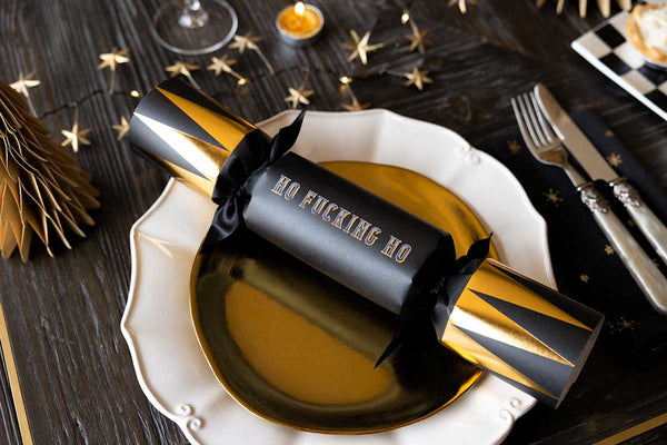 Image of a black and gold cracker on a gold plate.
