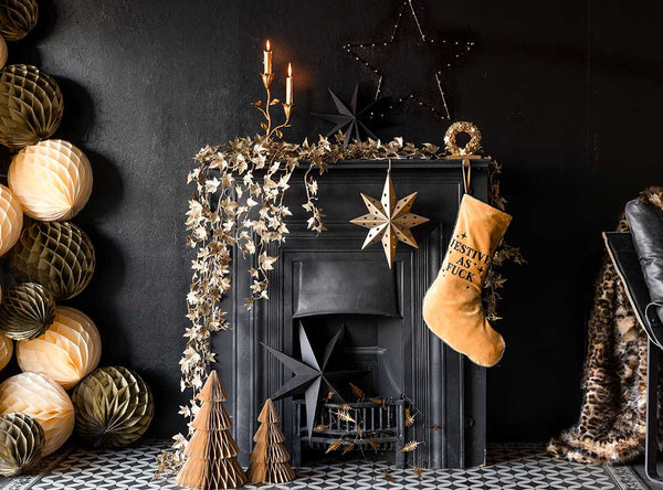 Dark fireplace with garlands, stockings and honeycomb balls.