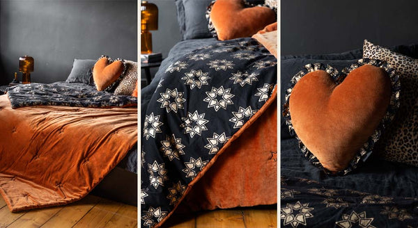 Images showing a burnt orange velvet reversible throw with a black and gold block-printed star pattern on the reverse and a matching ruffled heart cushion.