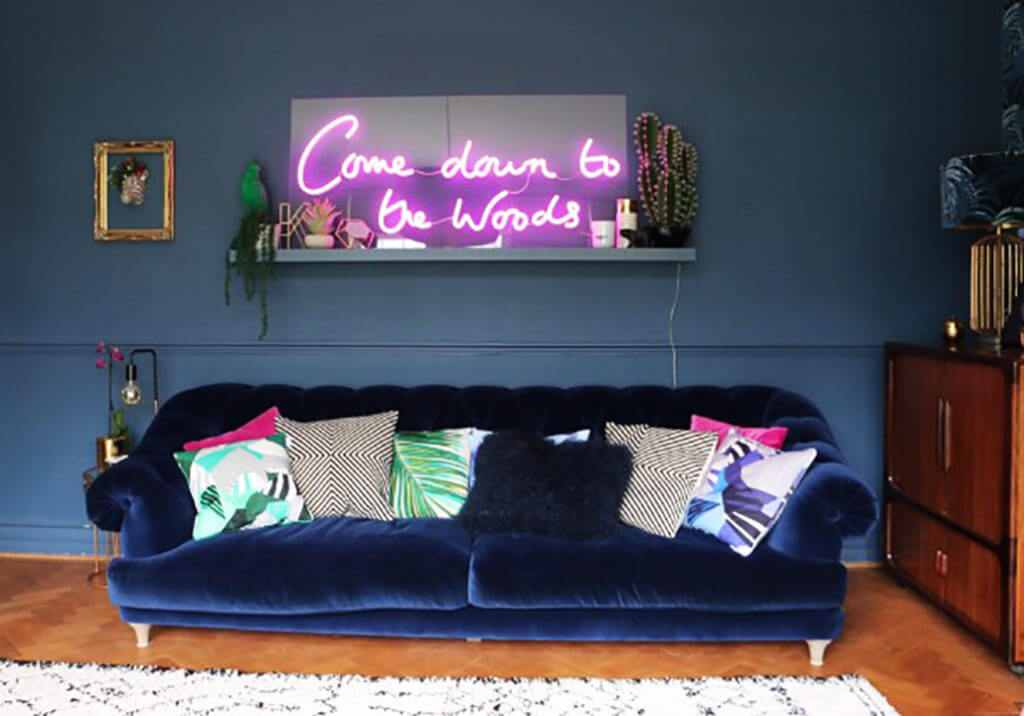 COME DOWN TO THE WOODS NEON SIGN AND SOFA LIVING ROOM