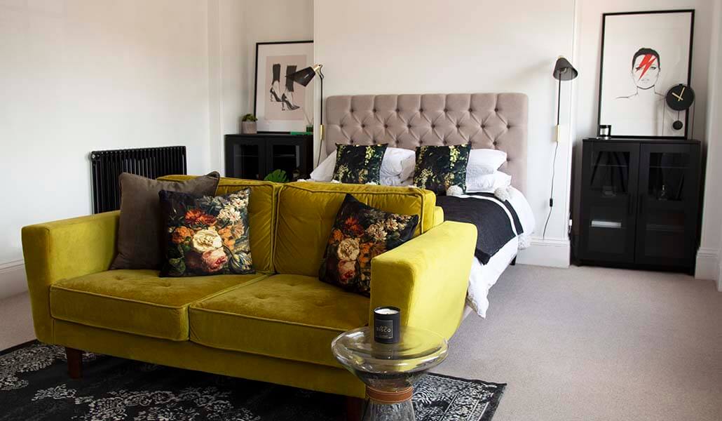 bedroom with lime green sofa and rsg revive rug and summer flowers cushions