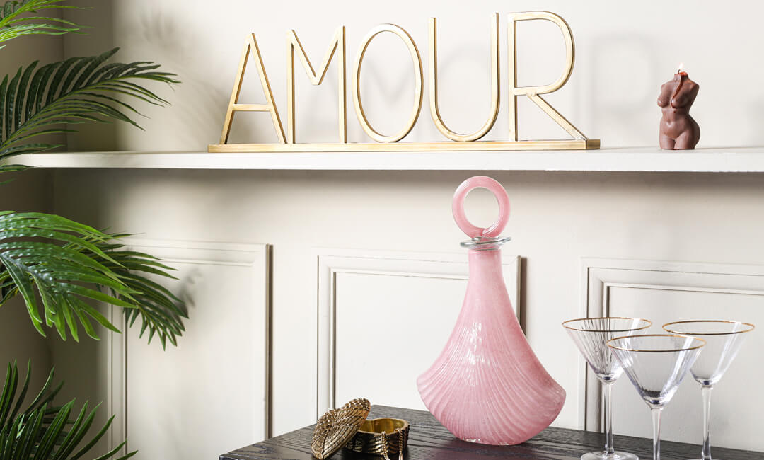 image showing a collection of wedding gift ideas including glasses, an art deco decanter and gold 'Amour' sign