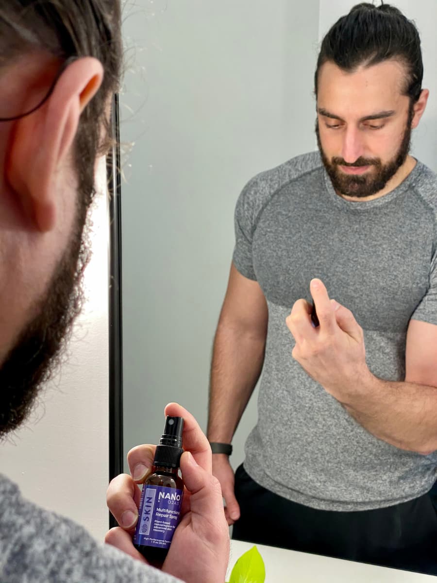 Person Holding Nano-Ojas in front of a Mirror