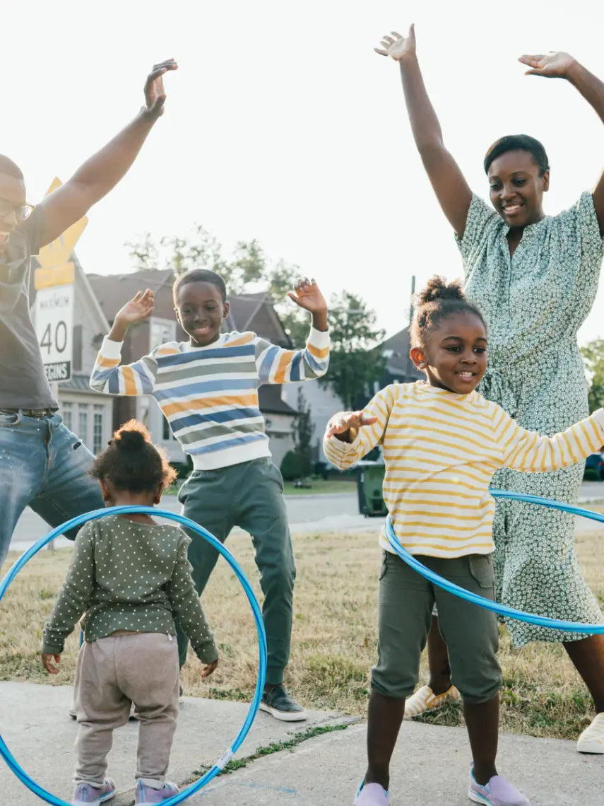 family active and outside dancing and playing with hula hoops