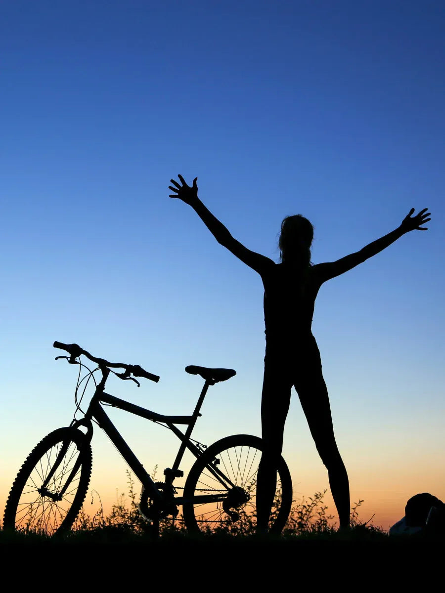 female standing with a bicycle