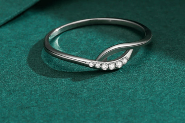 Sterling Silver Twist of Elegance Sparkle Ring featuring diamond accents on a green velvet background.