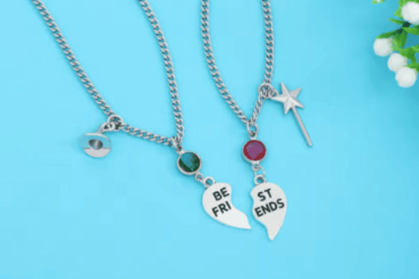 Necklace with green gemstone and wizard hat, and a necklace with red gemstone and star-tipped wand