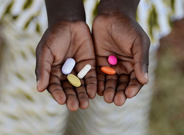 Boy holding pills to cure diseases.