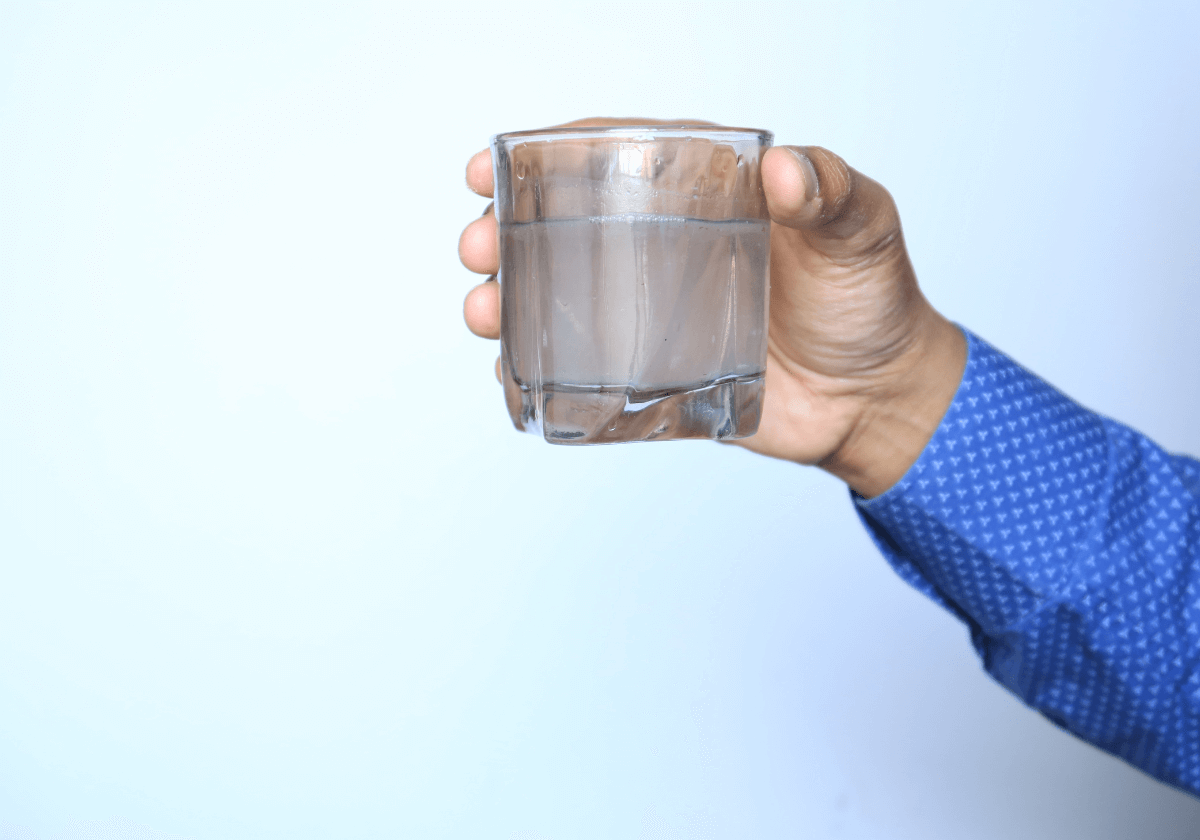 a glass of contaminated water