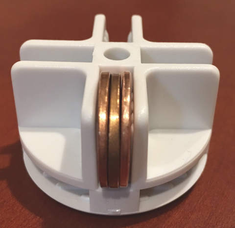 Three pennies inside white CCCages connector