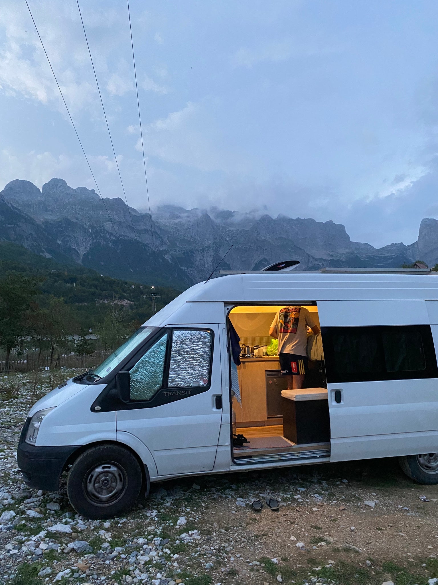 white camper van parked in front of mountains