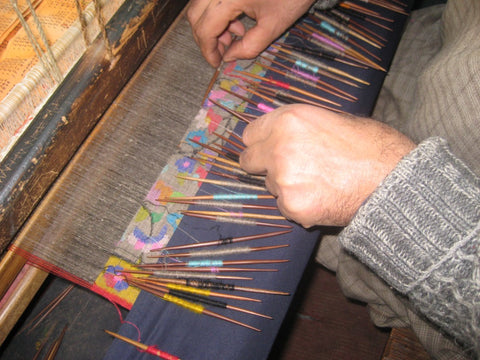 Kani shawl making process in kashmir on a wooden handloom with multi color Kani colours