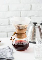 Chemex coffee brewer sitting on a white counter