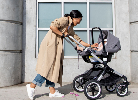 Woman playing with baby in stroller