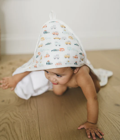 Baby wearing hooded towel by loulou lollipop