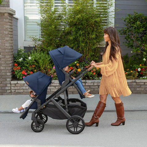 woman pushing uppababy double stroller