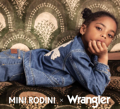 Girl wearing a jean jacket by Mini Rodini x Wrangler