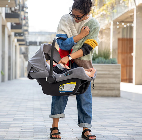 Woman holding baby in bugaboo turtle air car seat