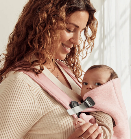 Woman carrying baby with best infant carrier