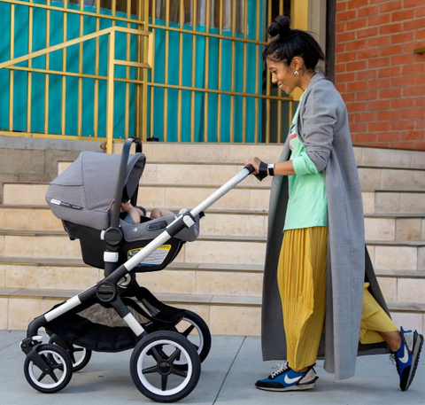 Woman strolling bugaboo fox and car seat compatible with it