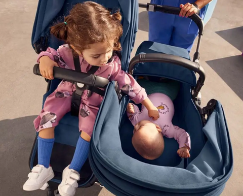 Two kids in a bugaboo donkey stroller