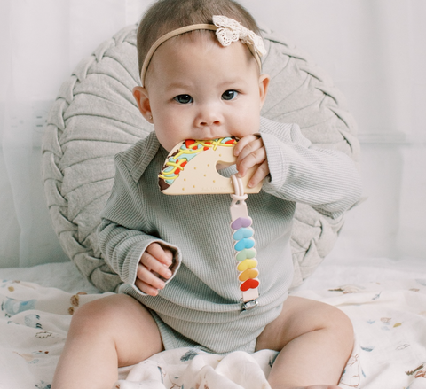 Baby using a Loulou lollipop taco teether