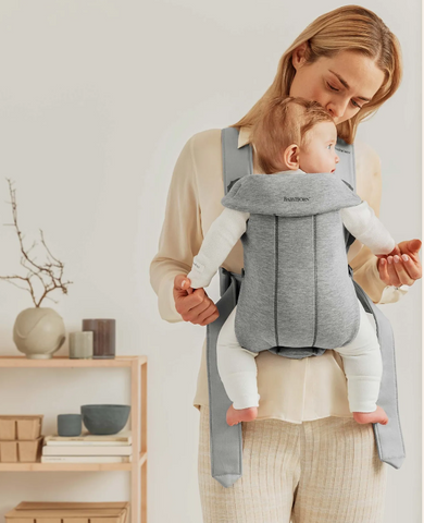 Woman carrying baby with her travel with baby carrier