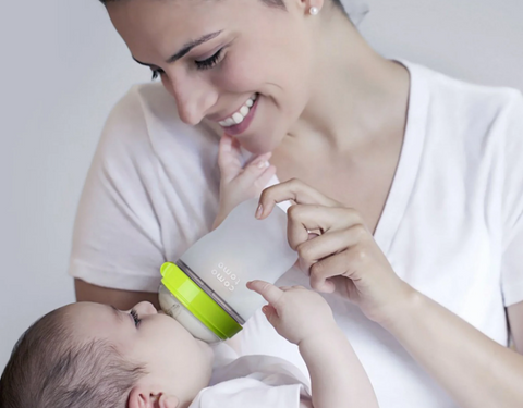 Woman feeding baby with a bottle