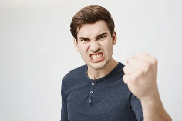 A guy clenching his teeth in anger