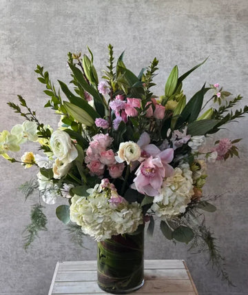 A custom Coastal Calm flower arrangement with whites, blues, and greens.
