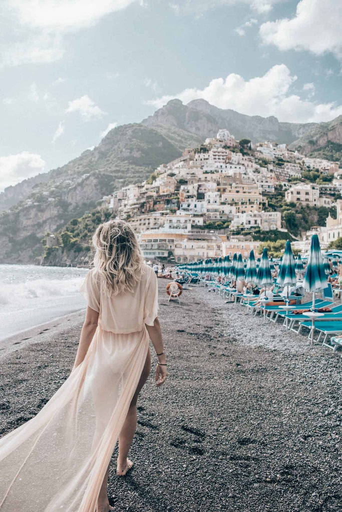 Meghan Knudson walking on the beach santorini greece