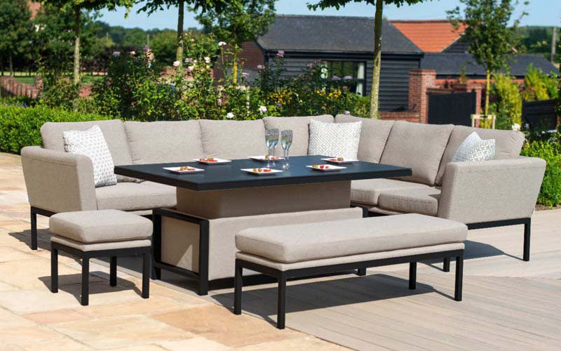 Elegant Pulse Left Handed Rectangular Corner Dining Set with Rising Table in a lush garden setting, perfect for outdoor dining and social gatherings.
