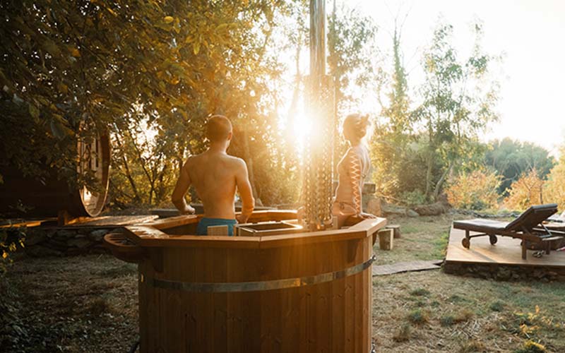 Couple enjoying Viking Industrier Hot Tub Health Benefits in nature.